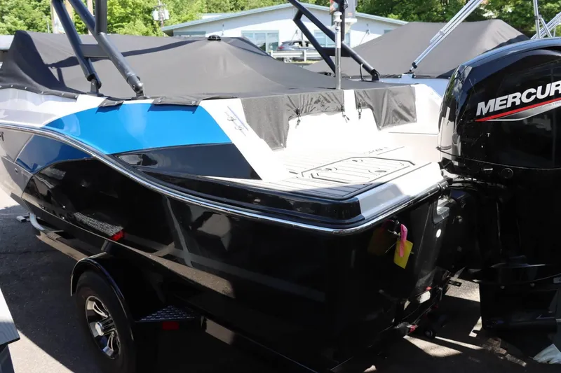 Slide: The Image of 2024 Starcraft SVX 190 OB boat with Mercury outboard motor, black and blue exterior. - 8