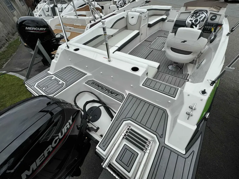 Slide: The Image of 2024 Starcraft SVX 191 OB boat with Mercury outboard motor, featuring spacious seating and modern dashboard. - 12