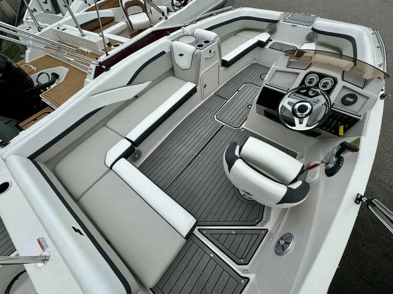 Slide: The Image of 2024 Starcraft SVX 191 OB boat interior with modern seating and steering console. - 14