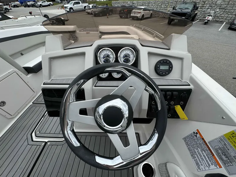 Slide: The Image of 2024 Starcraft SVX 191 OB boat dashboard with steering wheel and gauges. - 15