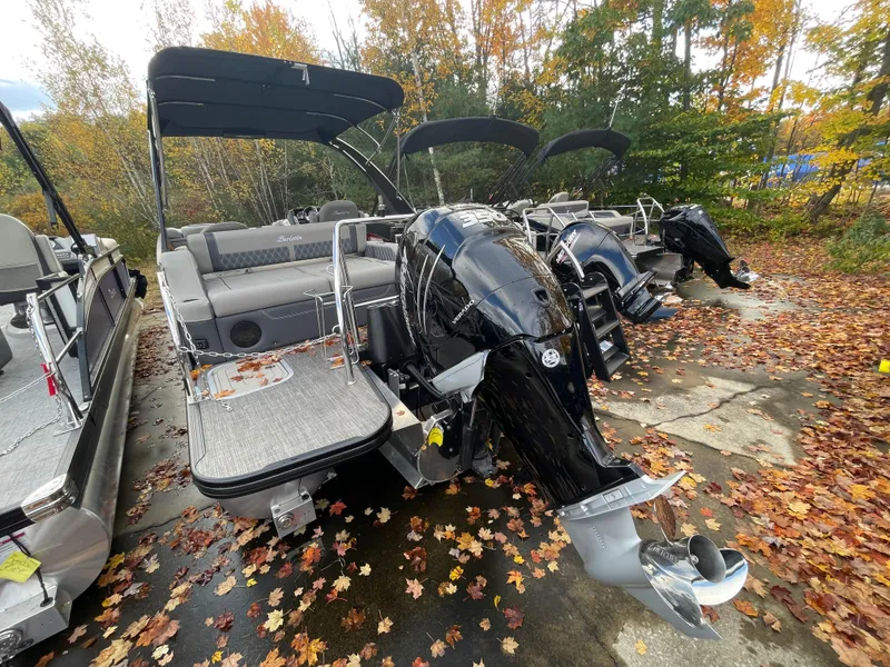 Slide: The Image of 2023 Barletta Lusso 23UCA pontoon boat with powerful outboard motor, parked on autumn leaves. - 10