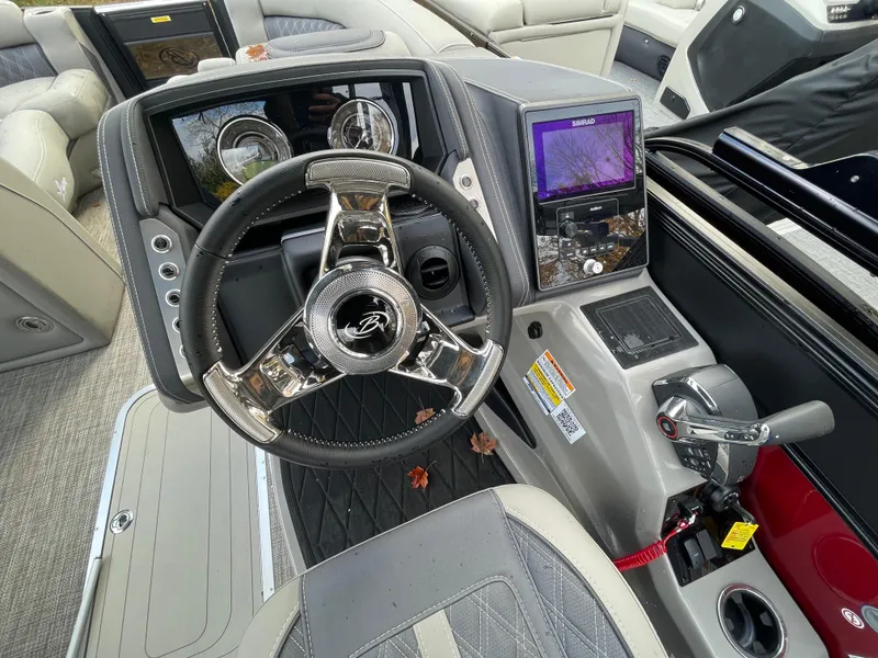 Slide: The Image of 2023 Barletta Lusso 23UCA boat dashboard with steering wheel and control panel. - 13
