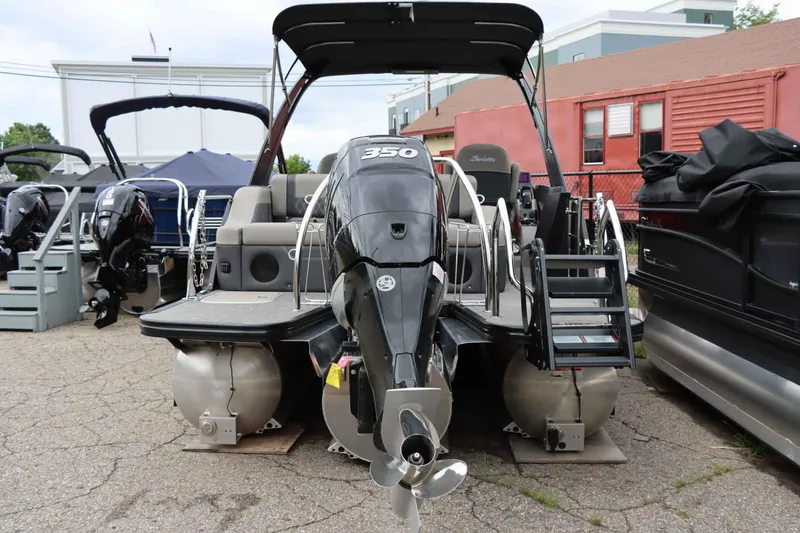 Slide: The Image of 2023 Barletta Lusso 23UCA pontoon boat with powerful outboard motor, docked outdoors. - 5