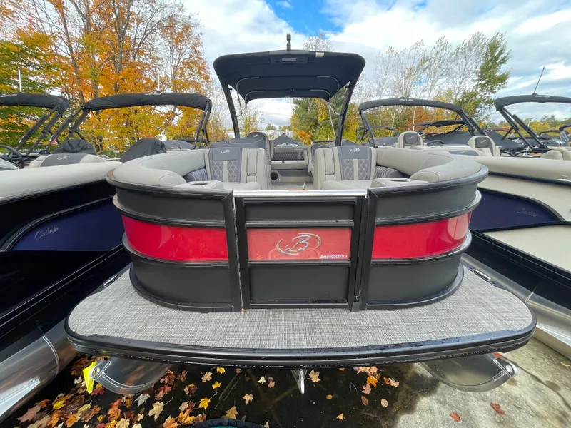 Slide: The Image of 2023 Barletta Lusso 23UCA pontoon boat with luxurious seating, docked in autumn setting. - 7
