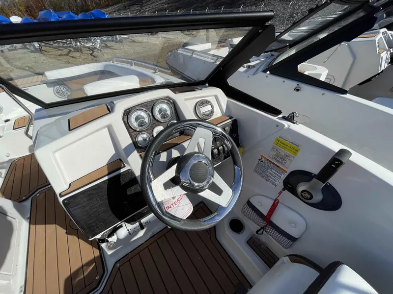 Slide: The Image of 2023 Starcraft SVX 210 OB boat dashboard with steering wheel and control panel. - 10