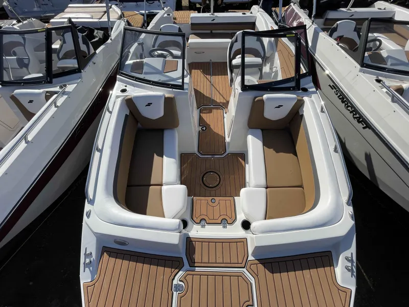 Slide: The Image of 2023 Starcraft SVX 210 OB boat interior with tan and white seating. - 15