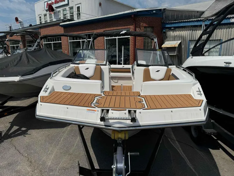 Slide: The Image of 2023 Starcraft SVX 210 OB boat on display at a dealership. - 3