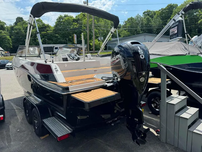 Slide: The Image of 2023 Starcraft SVX 210 OB boat with Mercury 150 outboard motor on trailer. - 4