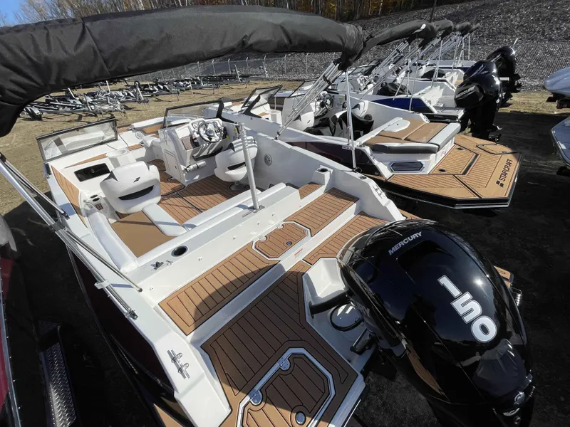 Slide: The Image of 2023 Starcraft SVX 210 OB boat with Mercury 150 outboard engine, docked in a marina. - 6