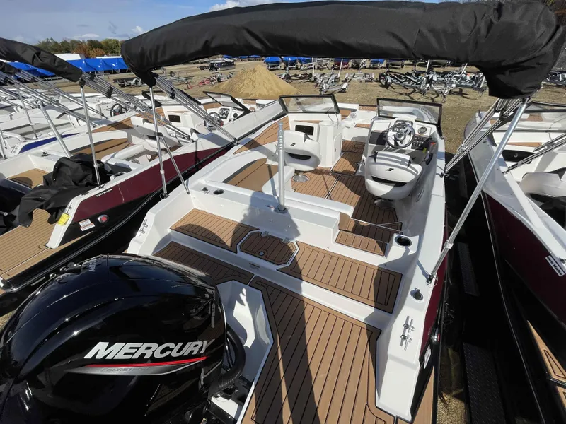 Slide: The Image of 2023 Starcraft SVX 210 OB boat with Mercury outboard engine, docked and ready for use. - 7