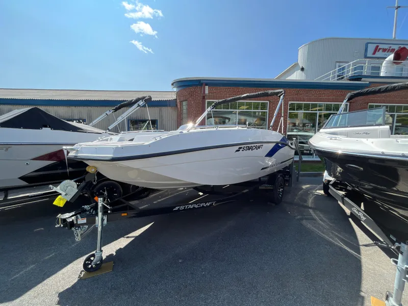 Slide: The Image of 2023 Starcraft SVX 171 OB boat on display at a dealership. - 1