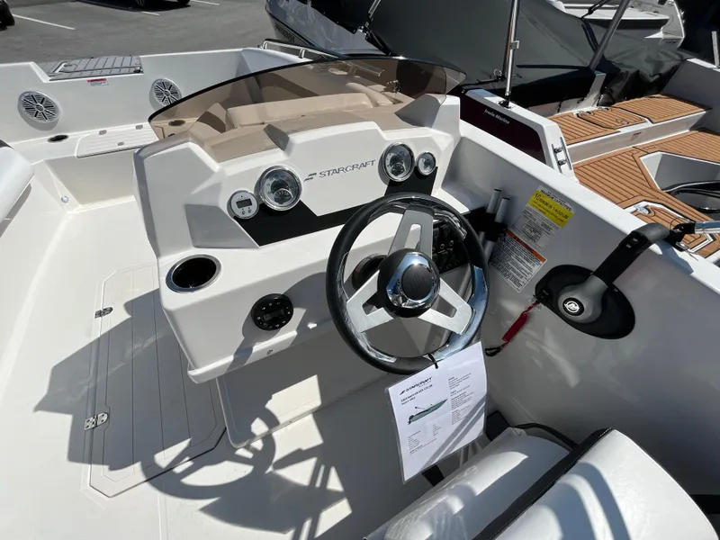 Slide: The Image of 2023 Starcraft SVX 171 OB boat dashboard with steering wheel and controls. - 7