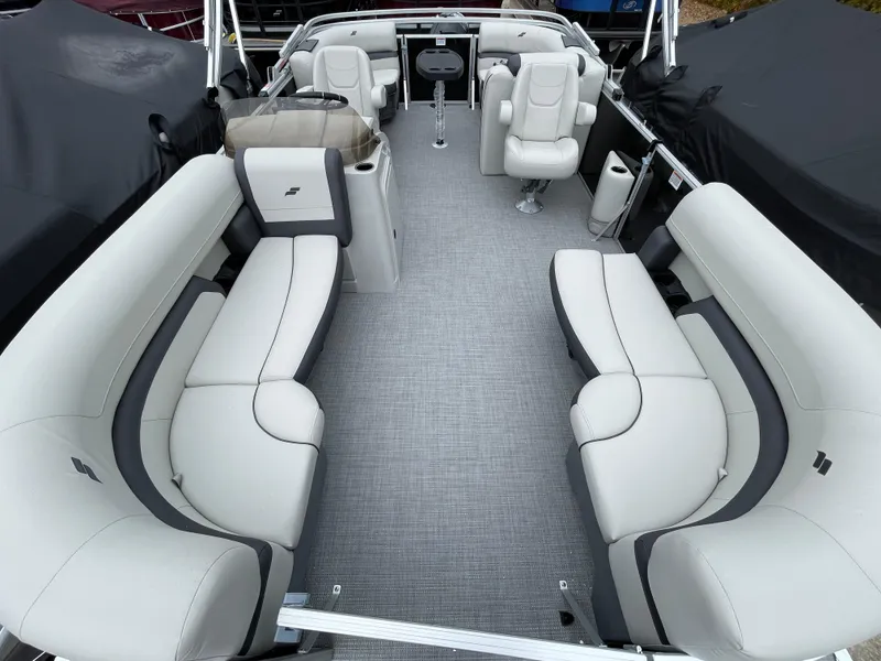 Slide: The Image of 2024 Starcraft EX 20R pontoon boat interior with plush seating and modern design. - 10