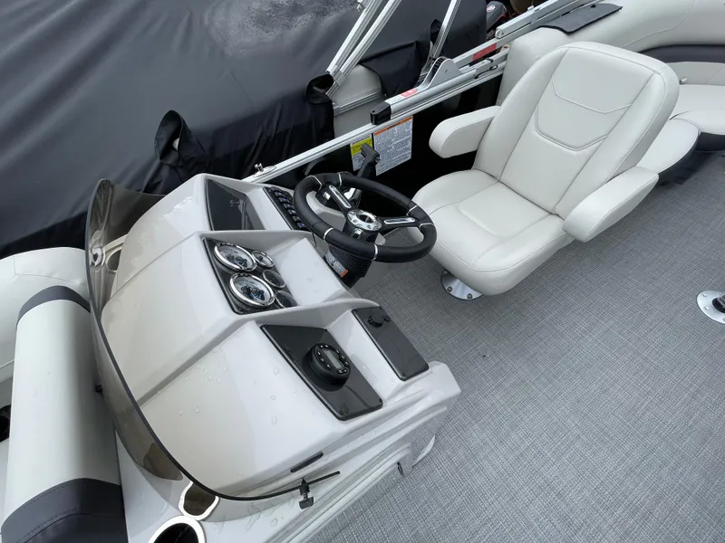 Slide: The Image of 2024 Starcraft EX 20R boat interior with steering console and captain's chair. - 11