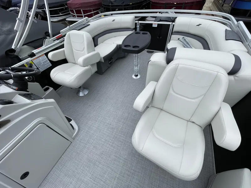 Slide: The Image of 2024 Starcraft EX 20R pontoon boat interior with white seating and steering console. - 12