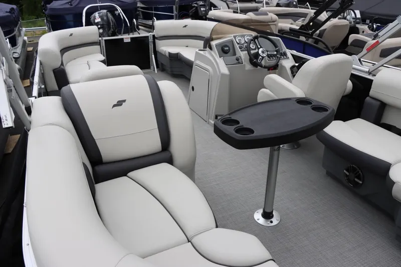 Slide: The Image of 2024 Starcraft EX 20R pontoon boat interior with plush seating and modern helm. - 14