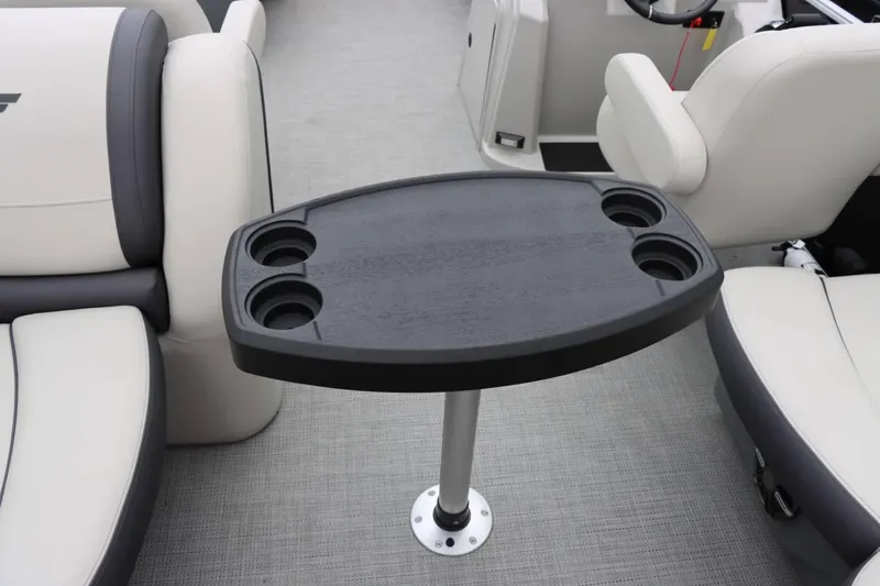 Slide: The Image of 2024 Starcraft EX 20R boat interior with table and cup holders. - 16