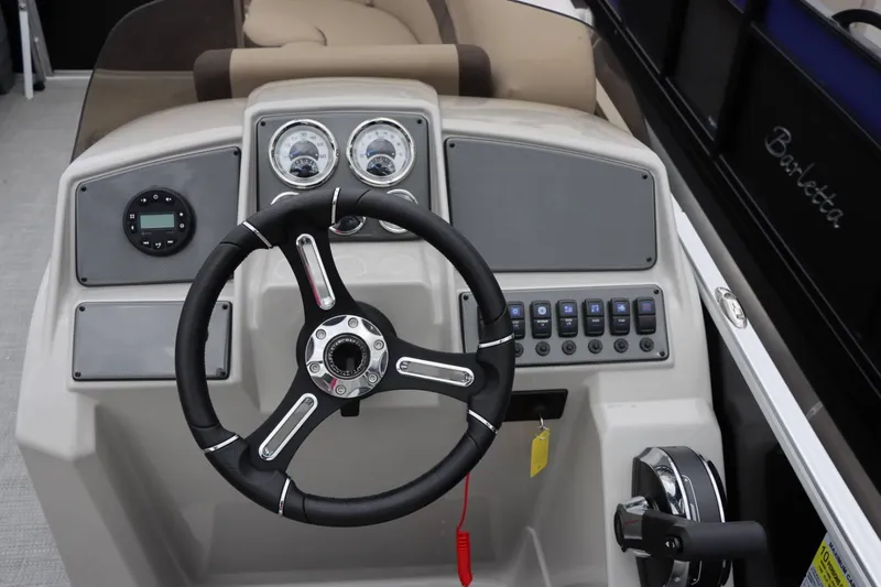 Slide: The Image of 2024 Starcraft EX 20R boat dashboard with steering wheel and control panel. - 17