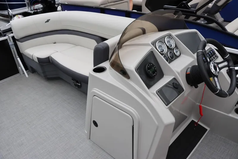 Slide: The Image of 2024 Starcraft EX 20R pontoon boat interior with helm and seating area. - 19