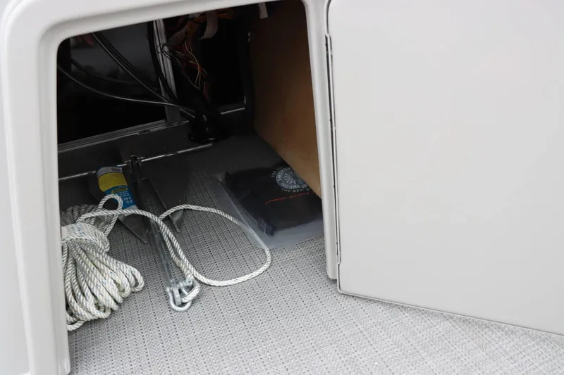 Slide: The Image of Storage compartment of 2024 Starcraft EX 20R boat with anchor and rope. - 22