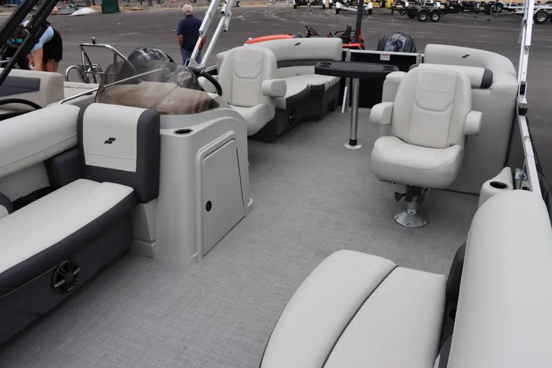 Slide: The Image of 2024 Starcraft EX 20R pontoon boat interior with plush seating and modern helm. - 23