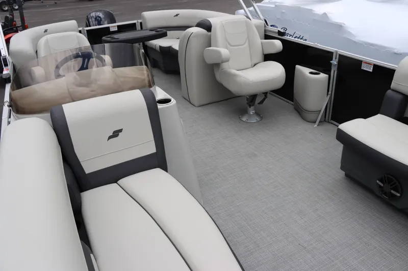 Slide: The Image of Interior of 2024 Starcraft EX 20R pontoon boat with plush seating and modern helm. - 24