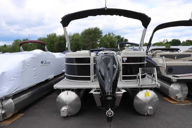 Slide: The Image of 2024 Starcraft EX 20R pontoon boat with outboard motor, docked in a marina. - 3
