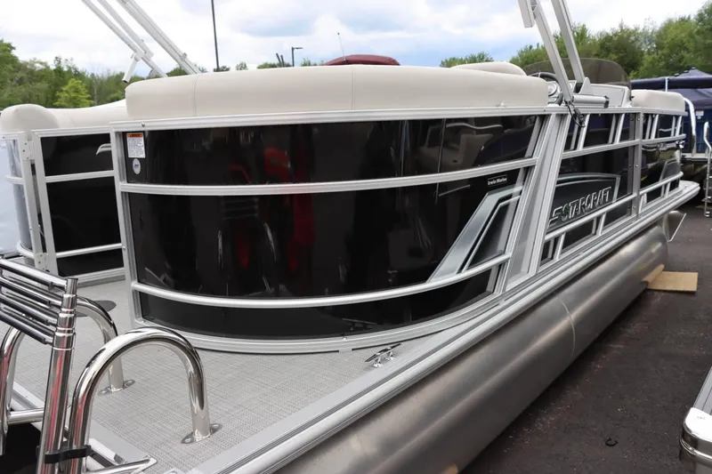 Slide: The Image of 2024 Starcraft EX 20R pontoon boat with sleek black exterior. - 5