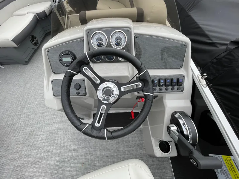Slide: The Image of 2024 Starcraft EX 20R boat dashboard with steering wheel and control panel. - 8