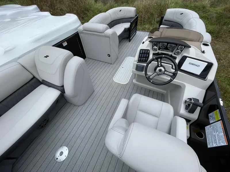 Slide: The Image of 2023 Starcraft CX 25DL BAR boat interior with luxurious seating and modern dashboard. - 6