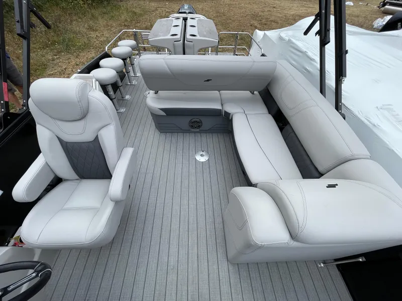 Slide: The Image of 2023 Starcraft CX 25DL BAR boat interior with white seating and bar stools. - 7