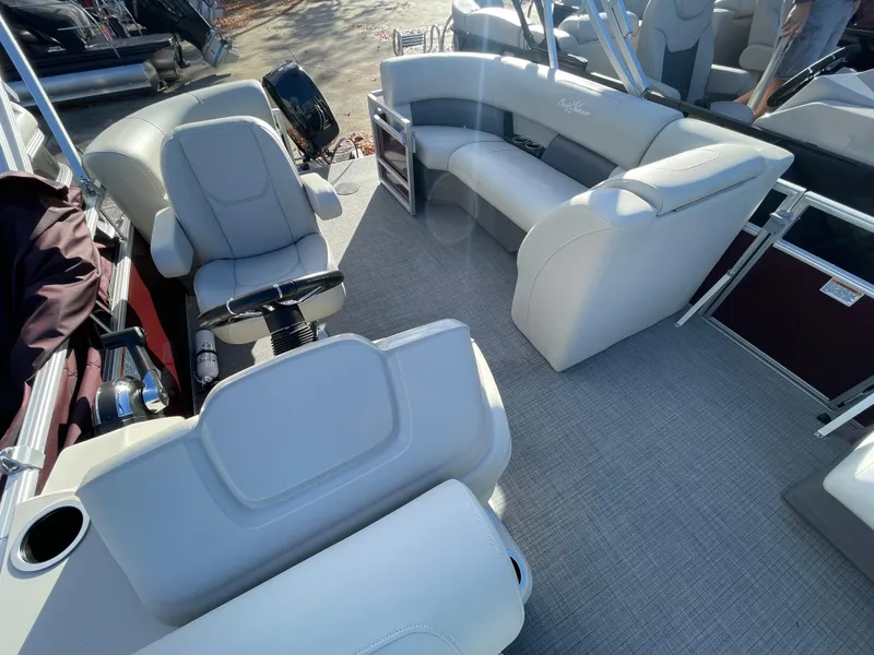 Slide: The Image of Interior of 2024 SunChaser VISTA 18LR pontoon boat with plush seating and steering console. - 10