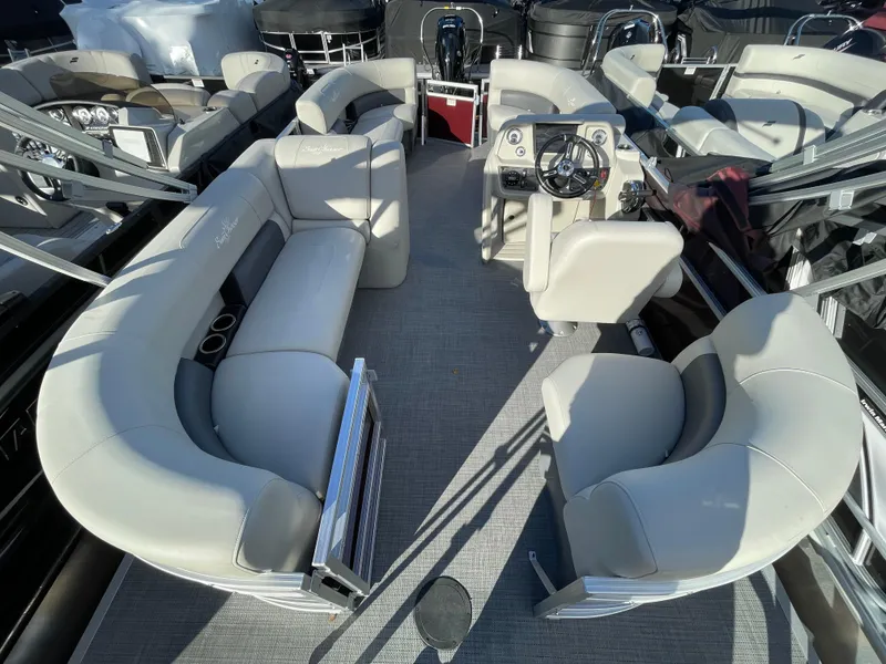 Slide: The Image of 2024 SunChaser VISTA 18LR pontoon boat interior with plush seating and modern helm. - 11