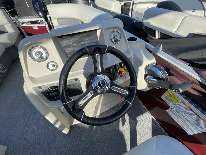Slide: The Image of 2024 SunChaser VISTA 18LR boat dashboard with steering wheel and control panel. - 12