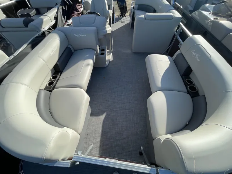 Slide: The Image of 2024 SunChaser VISTA 18LR boat interior with plush seating and cup holders. - 14