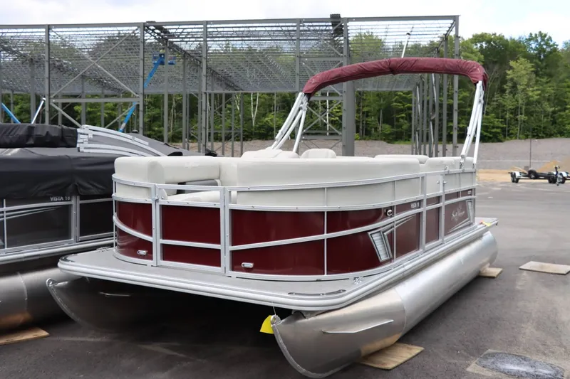 Slide: The Image of 2024 SunChaser VISTA 18LR pontoon boat with maroon and white exterior. - 7