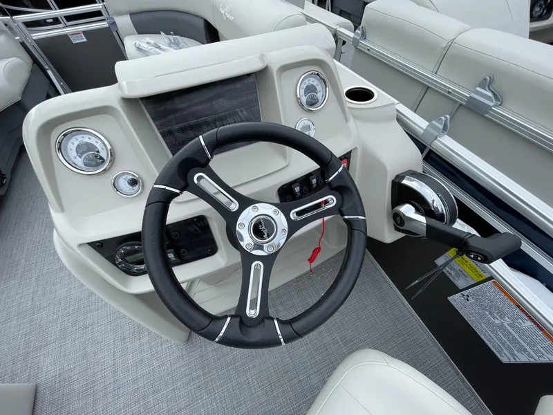 Slide: The Image of 2024 SunChaser VISTA 18LR boat dashboard with steering wheel and control panel. - 7