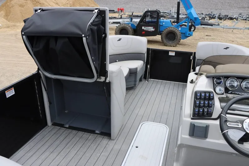 Slide: The Image of Interior of 2023 Starcraft SLS 3 pontoon boat with seating and control panel. - 13