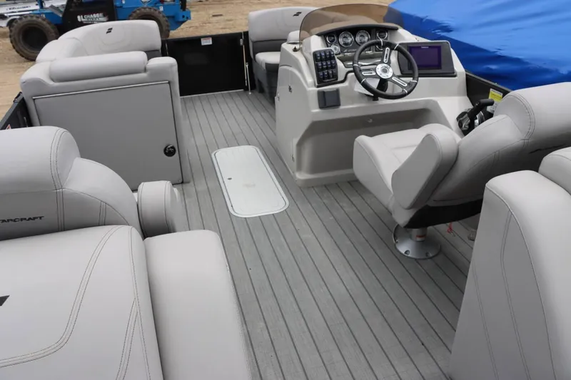 Slide: The Image of 2023 Starcraft SLS 3 boat interior with gray seating and modern dashboard. - 15