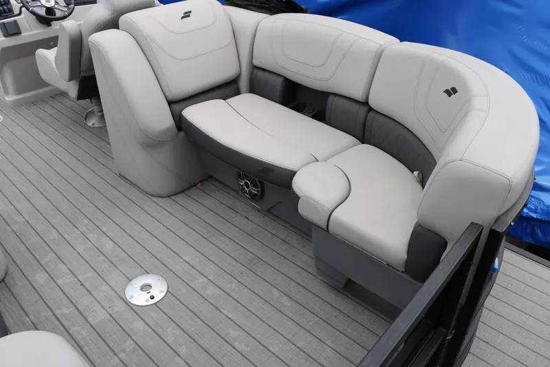 Slide: The Image of 2023 Starcraft SLS 3 boat interior with gray cushioned seating and steering console. - 20
