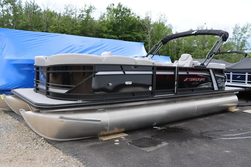 Slide: The Image of 2023 Starcraft SLS 3 pontoon boat in storage. - 3