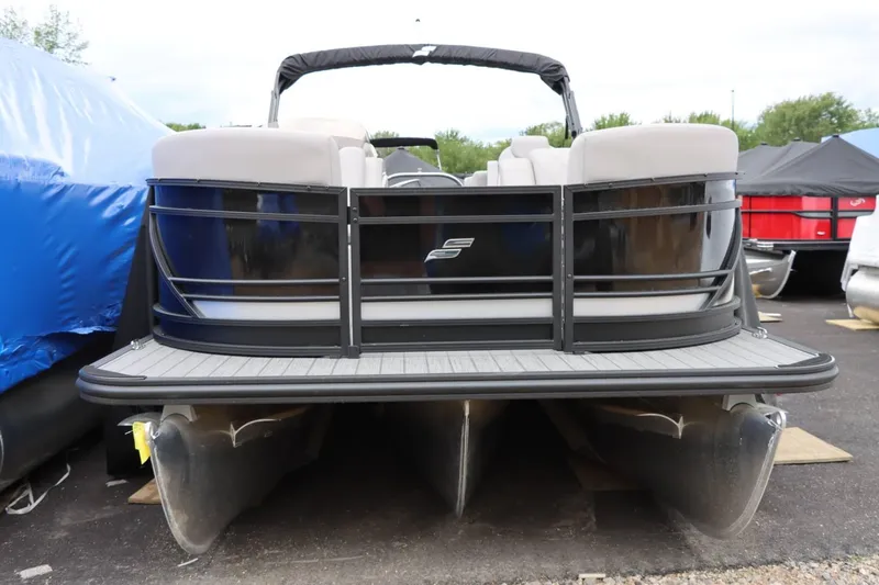 Slide: The Image of 2023 Starcraft SLS 3 pontoon boat, front view, parked outdoors. - 4