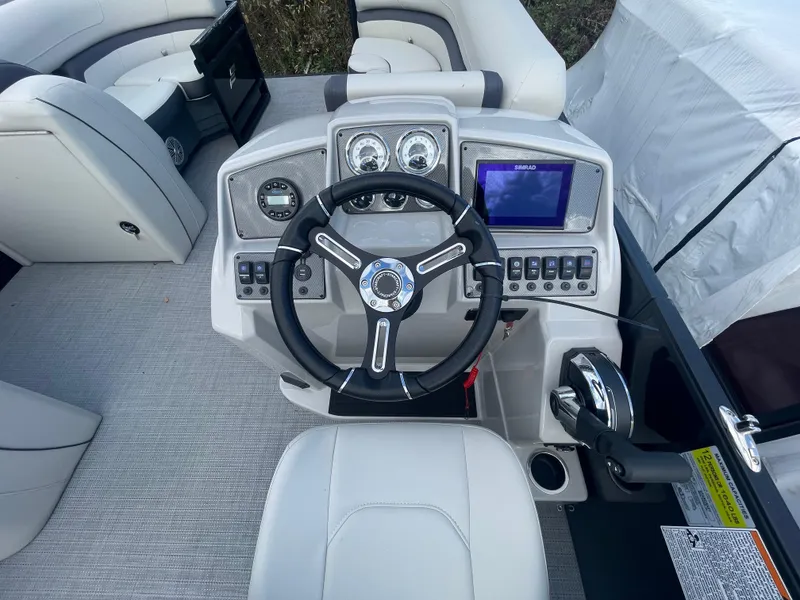 Slide: The Image of 2023 Starcraft EXS 3Q boat dashboard with steering wheel and control panel. - 10