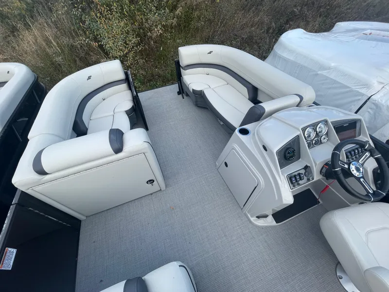 Slide: The Image of 2023 Starcraft EXS 3Q pontoon boat interior with plush seating and modern helm. - 12