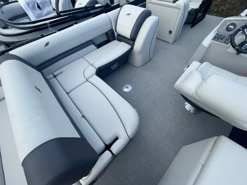 Slide: The Image of 2023 Starcraft EXS 3Q boat interior with white and gray seating. - 16