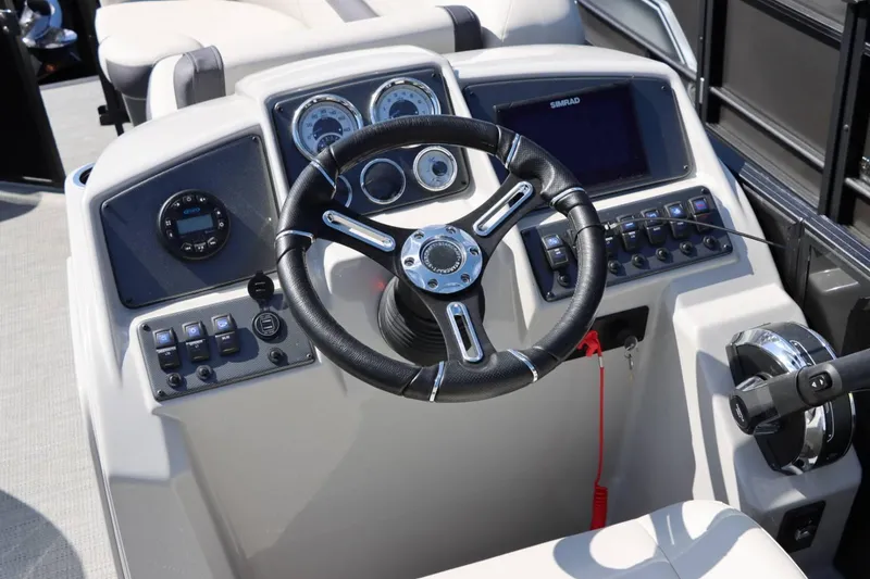 Slide: The Image of 2023 Starcraft EXS 3Q boat dashboard with steering wheel and control panel. - 21