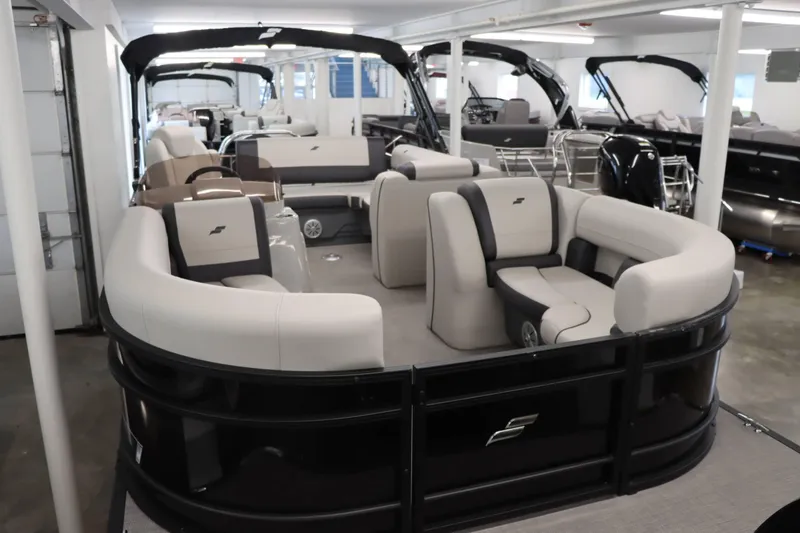 Slide: The Image of 2023 Starcraft EXS 3Q pontoon boat with luxurious seating in showroom. - 24