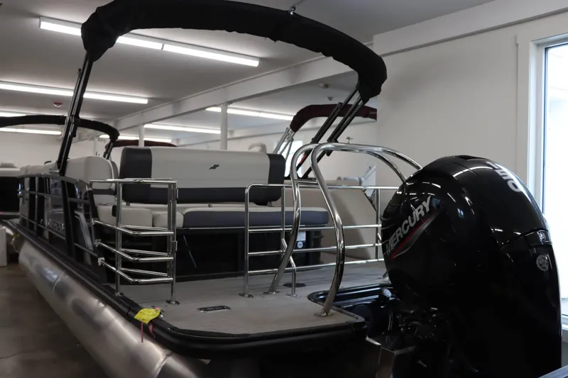 Slide: The Image of 2023 Starcraft EXS 3Q pontoon boat with Mercury outboard motor in showroom. - 25