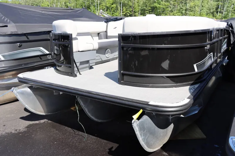 Slide: The Image of 2023 Starcraft EXS 3Q pontoon boat with black exterior and white seating. - 6