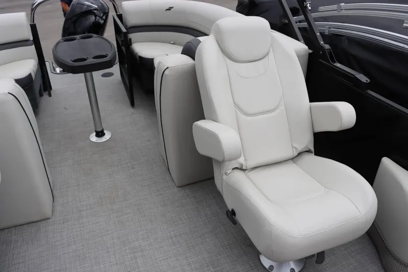 Slide: The Image of 2024 Starcraft EXS 3 boat interior with white leather seating and cup holder table. - 13